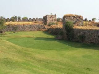 15th green at Hyderabad Golf Club with historic Naya Qila structure in the background